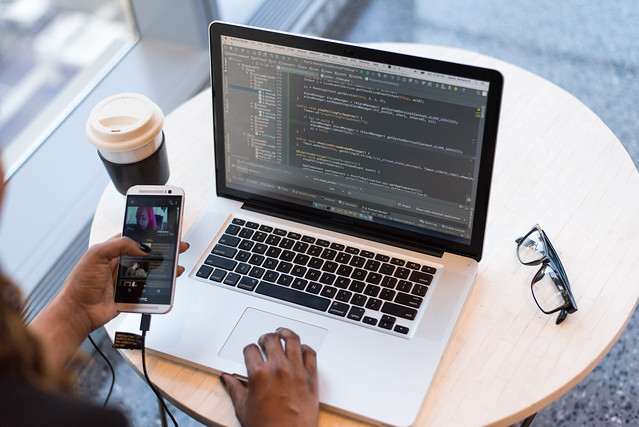 Black writer working on a notebook computer