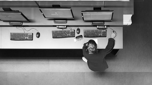 Overhead shot of a white woman doing research on a library computer