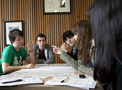 Group of college students around a table, sharing ideas